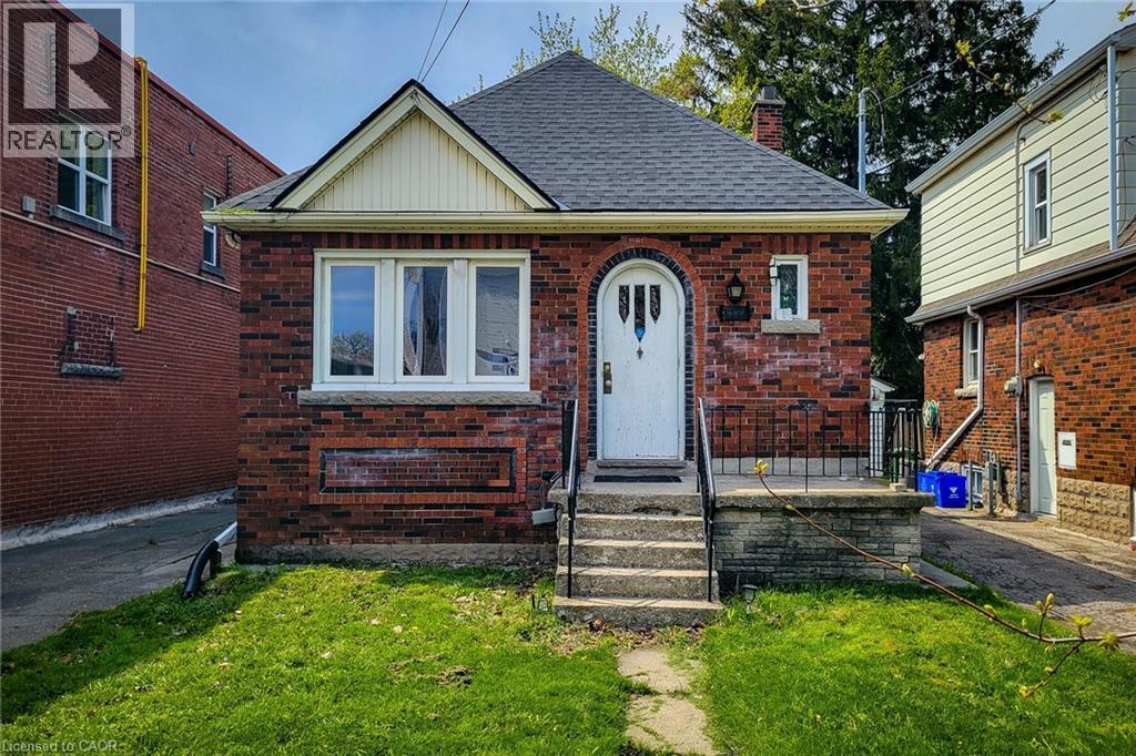 Brick bungalow featuring a steeply pitched roof and a front gable - 66 Cline Avenue Unit# Main Floor, Hamilton, ON - Outdoor With Exterior