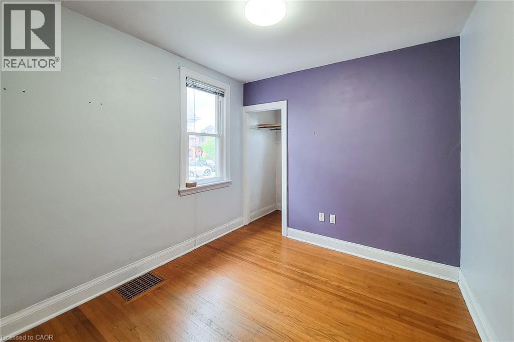 Room with hardwood flooring, a single window, and a recessed closet - 66 Cline Avenue Unit# Main Floor, Hamilton, ON - Indoor Photo Showing Other Room