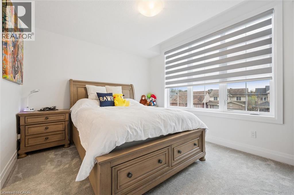 Bedroom with light grey carpeting and white baseboards - 213 Fallowfield Drive, Kitchener, ON - Indoor Photo Showing Bedroom