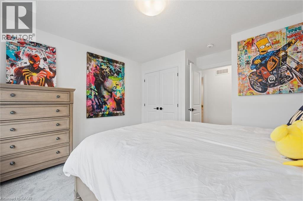 Bright room featuring white walls, light gray carpet, and a flush mount ceiling light - 213 Fallowfield Drive, Kitchener, ON - Indoor Photo Showing Bedroom