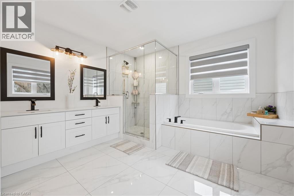 Spacious bathroom featuring white tiled flooring and walls - 213 Fallowfield Drive, Kitchener, ON - Indoor Photo Showing Bathroom