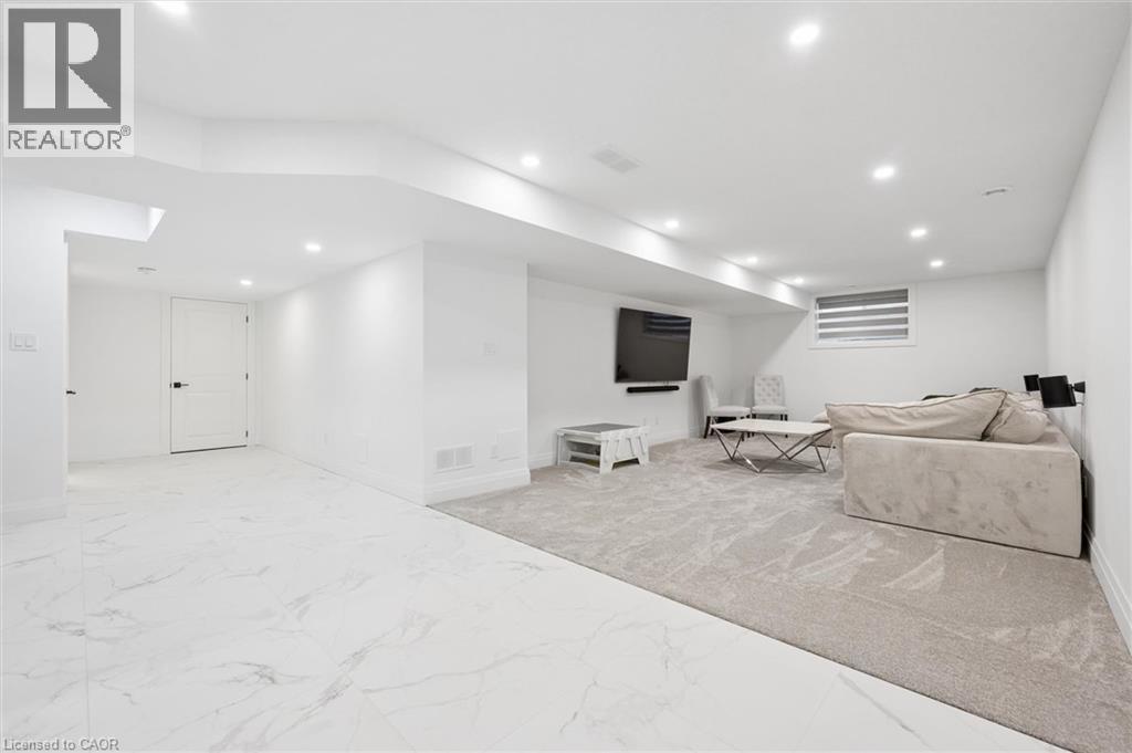 Spacious lower level featuring white walls and recessed lighting - 213 Fallowfield Drive, Kitchener, ON - Indoor
