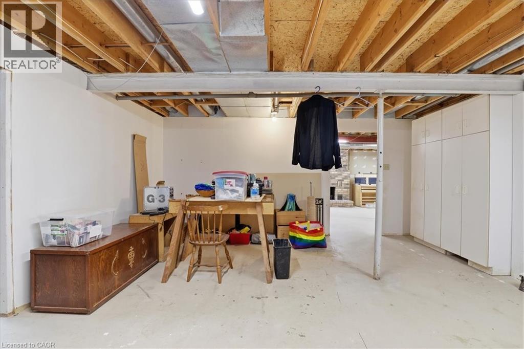 The property features an unfinished basement with white walls, exposed ceiling joists, and a concrete floor - 110 Milton Avenue, Cambridge, ON - Indoor Photo Showing Basement