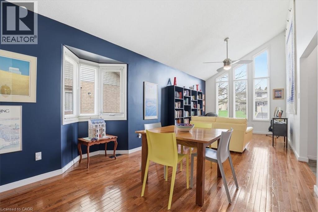 The open concept living area features hardwood floors, a bay window, and a vaulted ceiling with a ceiling fan - 110 Milton Avenue, Cambridge, ON - Indoor Photo Showing Dining Room