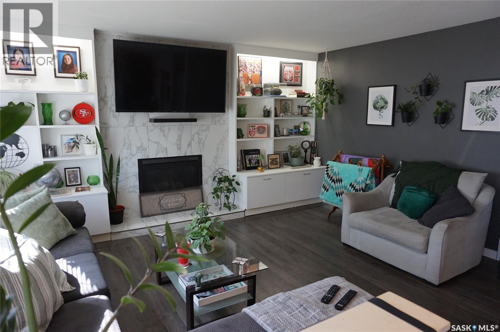 91 Plant Crescent, Regina, SK - Indoor Photo Showing Living Room With Fireplace
