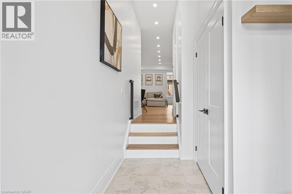 Entryway featuring light-toned tile flooring, recessed lighting, and a white paneled door with dark hardware - 1026 Wright Drive, Midland, ON - Indoor Photo Showing Other Room
