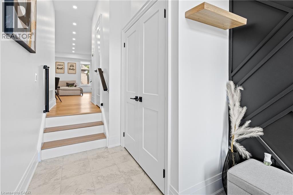 Entryway featuring tile flooring, white paneled doors with matte black hardware, and a decorative wall panel - 1026 Wright Drive, Midland, ON - Indoor Photo Showing Other Room