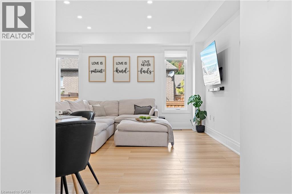Bright open-concept living area featuring light wood-finish flooring, recessed lighting, and crisp white walls - 1026 Wright Drive, Midland, ON - Indoor Photo Showing Living Room