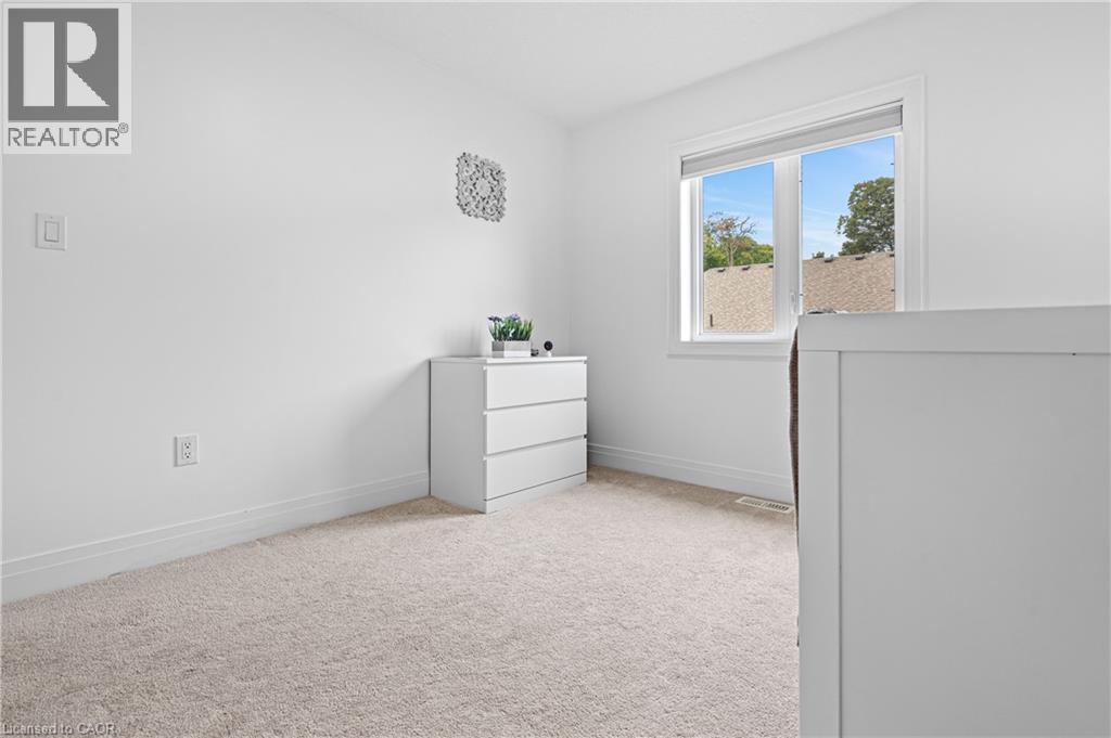 Bright interior space featuring a double-paned window, neutral wall paint, and light-toned carpeting - 1026 Wright Drive, Midland, ON - Indoor
