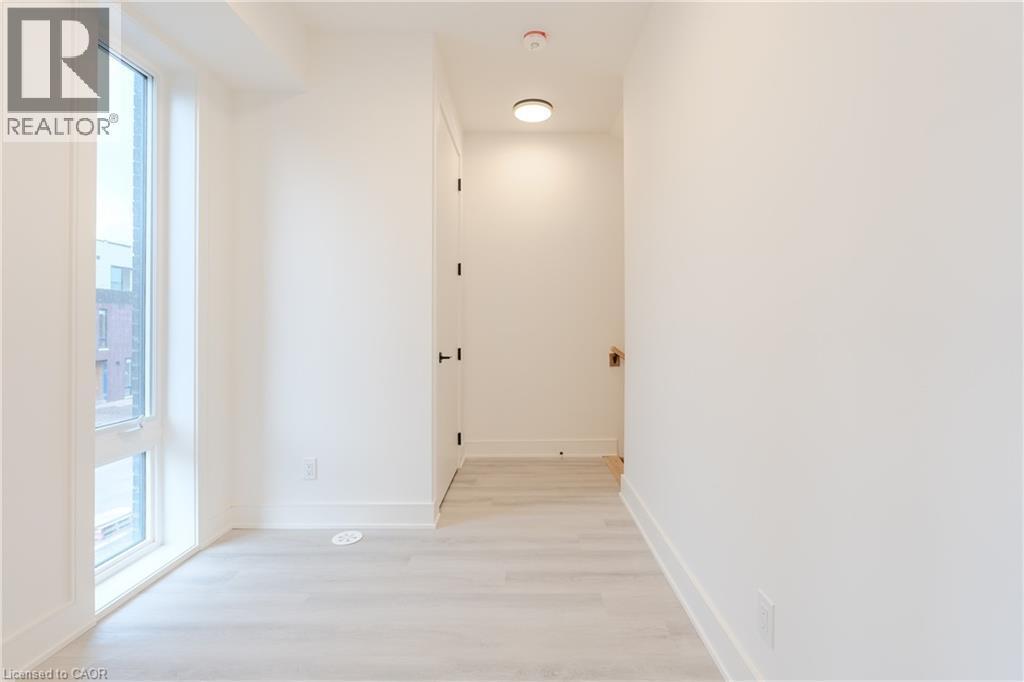 This bright interior space features light-toned flooring and white walls, creating an airy atmosphere - 144 Everett Common, St. Catharines, ON - Indoor Photo Showing Other Room
