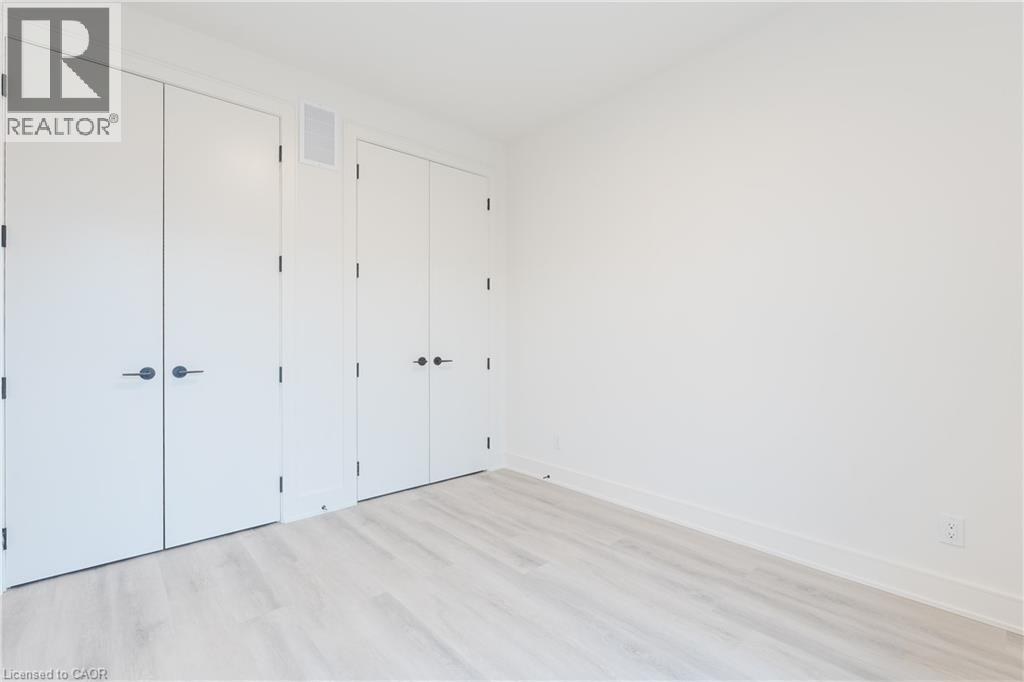 The room features light-colored flooring, white walls, and white doors with dark hardware - 144 Everett Common, St. Catharines, ON - Indoor Photo Showing Other Room