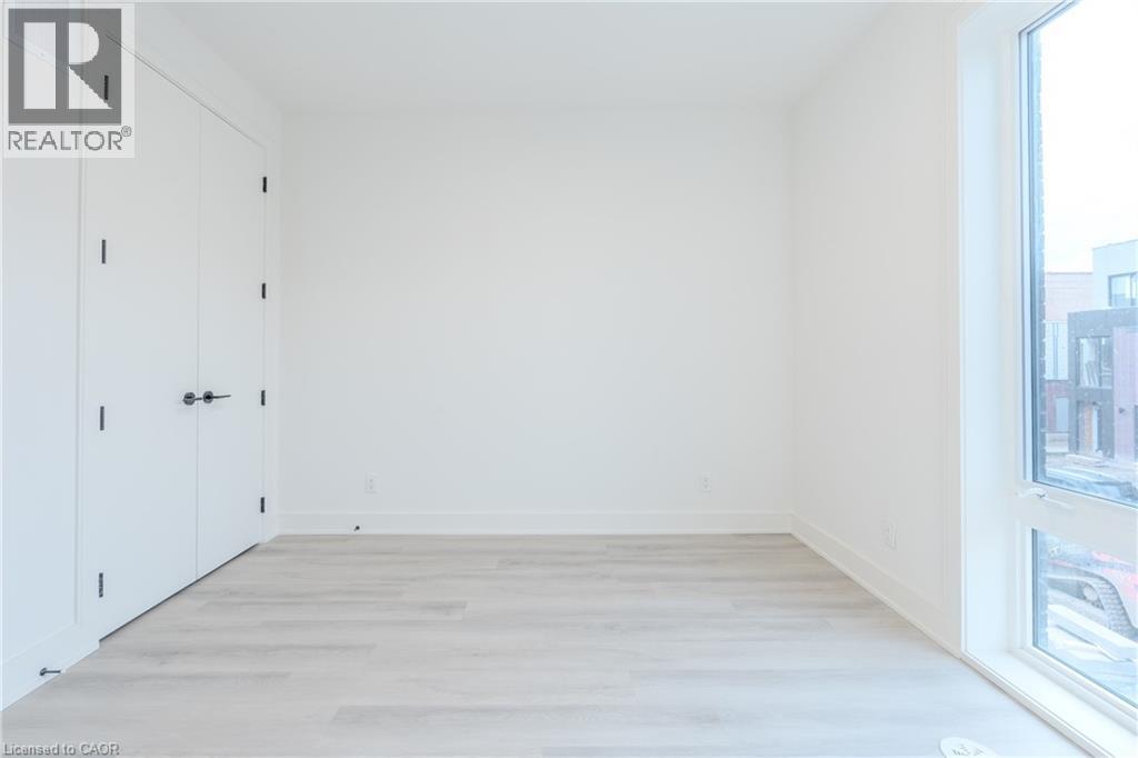 This room features light-toned flooring, white walls, and a window providing natural light - 144 Everett Common, St. Catharines, ON - Indoor Photo Showing Other Room