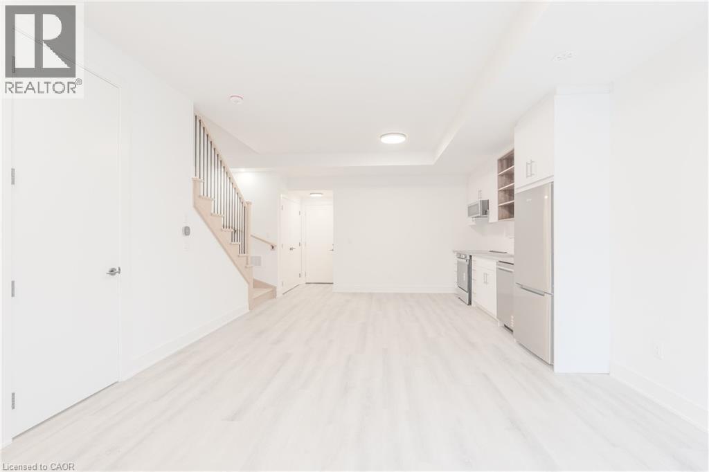 Bright and airy open-concept living area with light-toned flooring - 144 Everett Common, St. Catharines, ON - Indoor Photo Showing Other Room