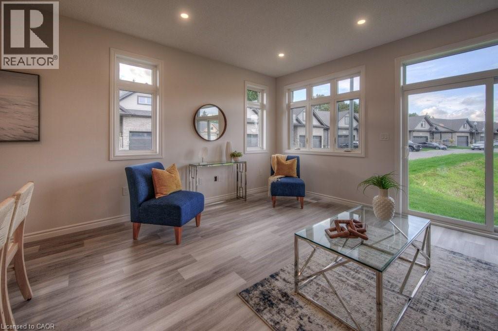 Bright living area featuring wood-finish flooring, recessed lighting, and white baseboards - 48 Main Street E, Innerkip, ON - Indoor