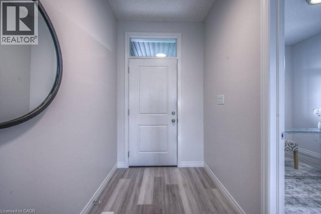 Entryway featuring wood-finish flooring, light grey wall paint, and white trim - 48 Main Street E, Innerkip, ON - Indoor Photo Showing Other Room