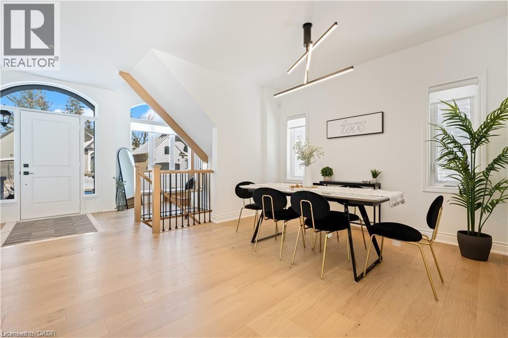 Dining room featuring light wood-type flooring and baseboards - 66 Cesar Place, Ancaster, ON - Indoor