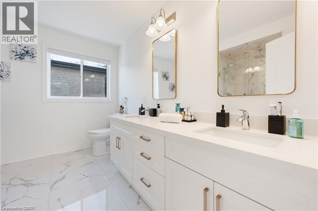 Full bathroom featuring a marble finish shower, double vanity, and light marble finish floors - 66 Cesar Place, Ancaster, ON - Indoor Photo Showing Bathroom