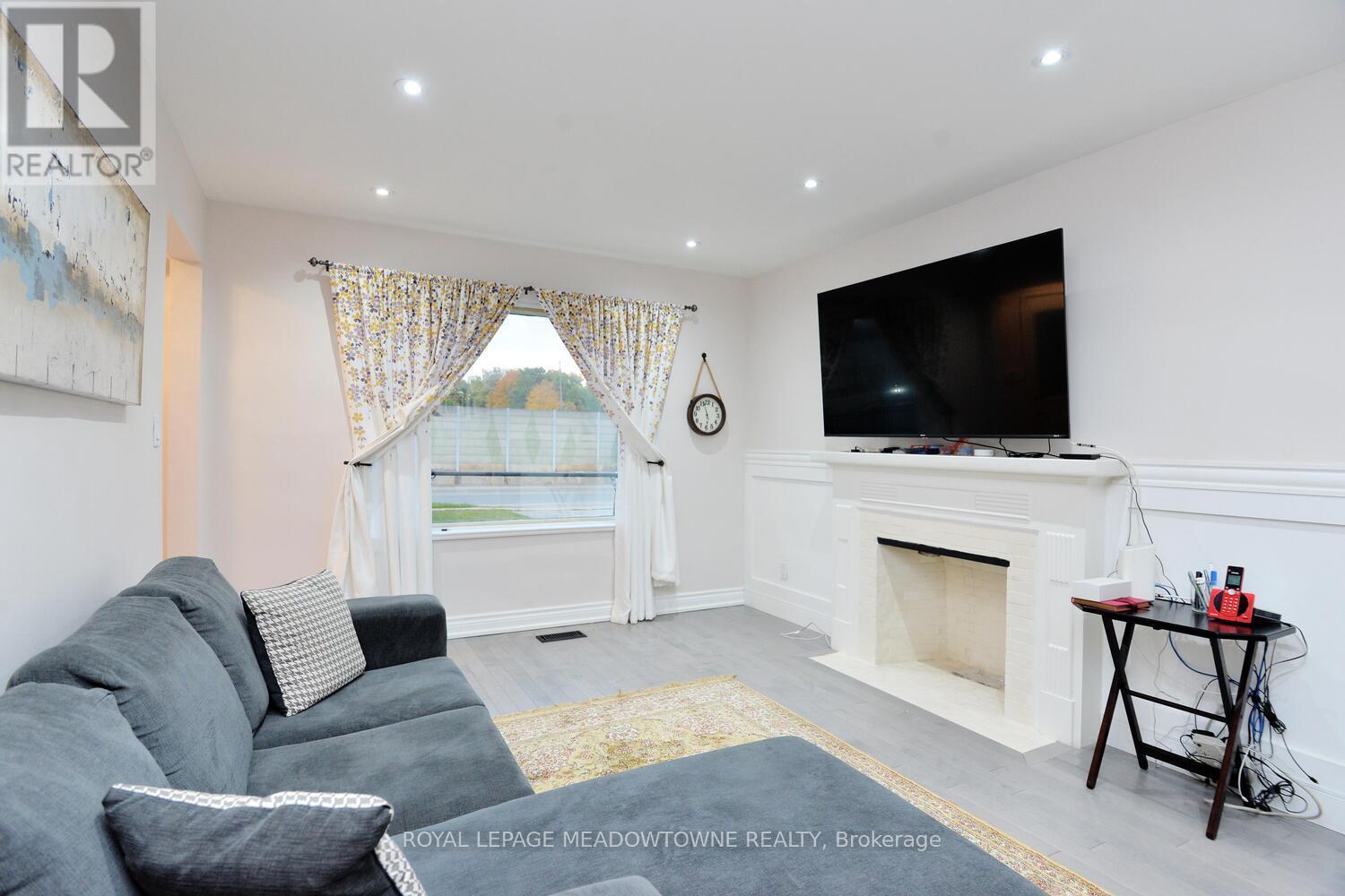 825 North Service Road, Mississauga, ON - Indoor Photo Showing Living Room With Fireplace