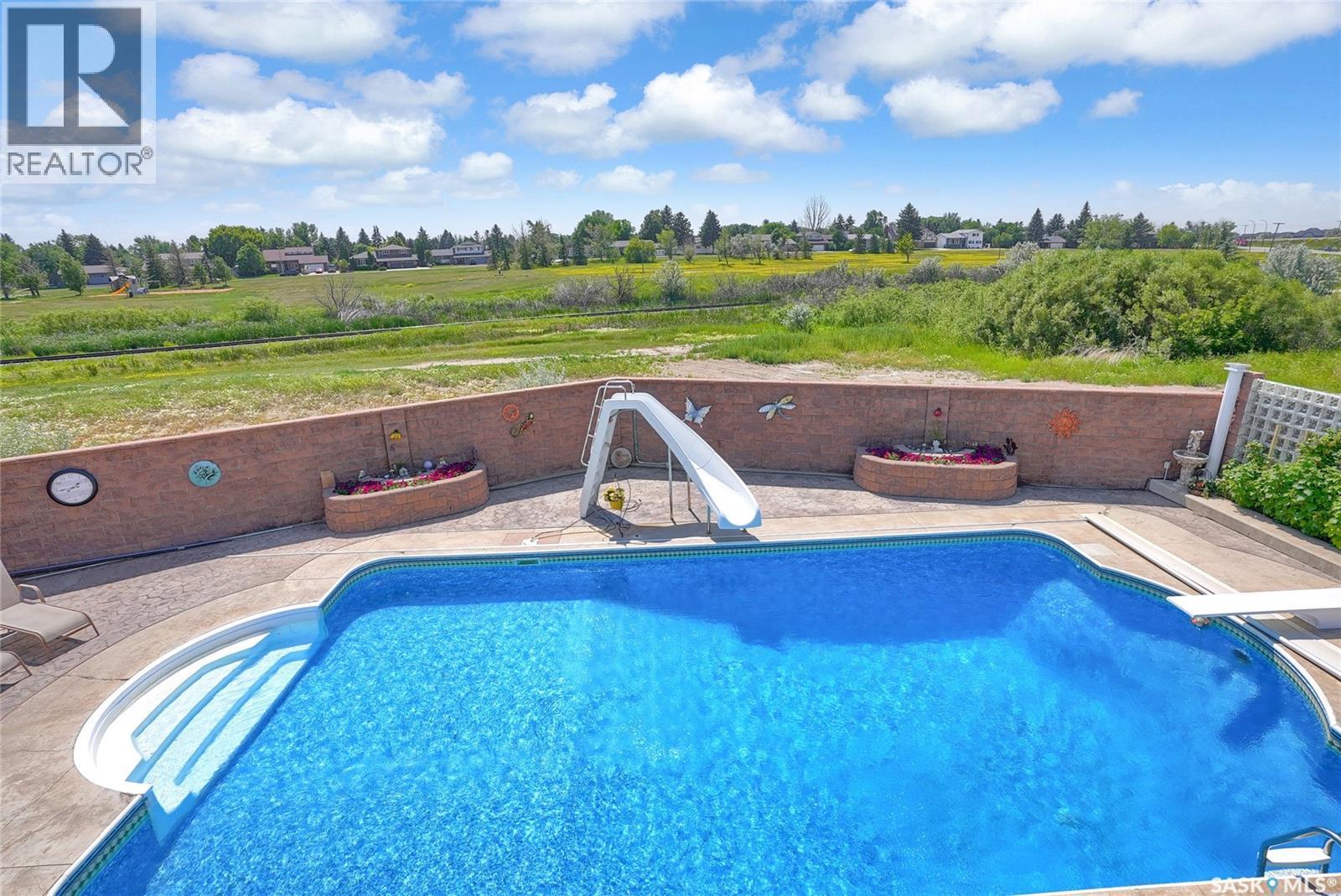 1453 Normandy Drive, Moose Jaw, SK - Outdoor With In Ground Pool With Deck Patio Veranda With View