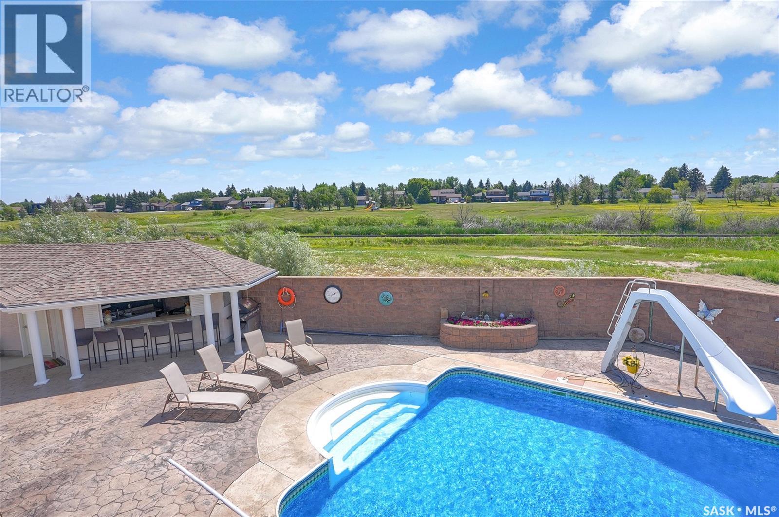 1453 Normandy Drive, Moose Jaw, SK - Outdoor With In Ground Pool With Deck Patio Veranda With View