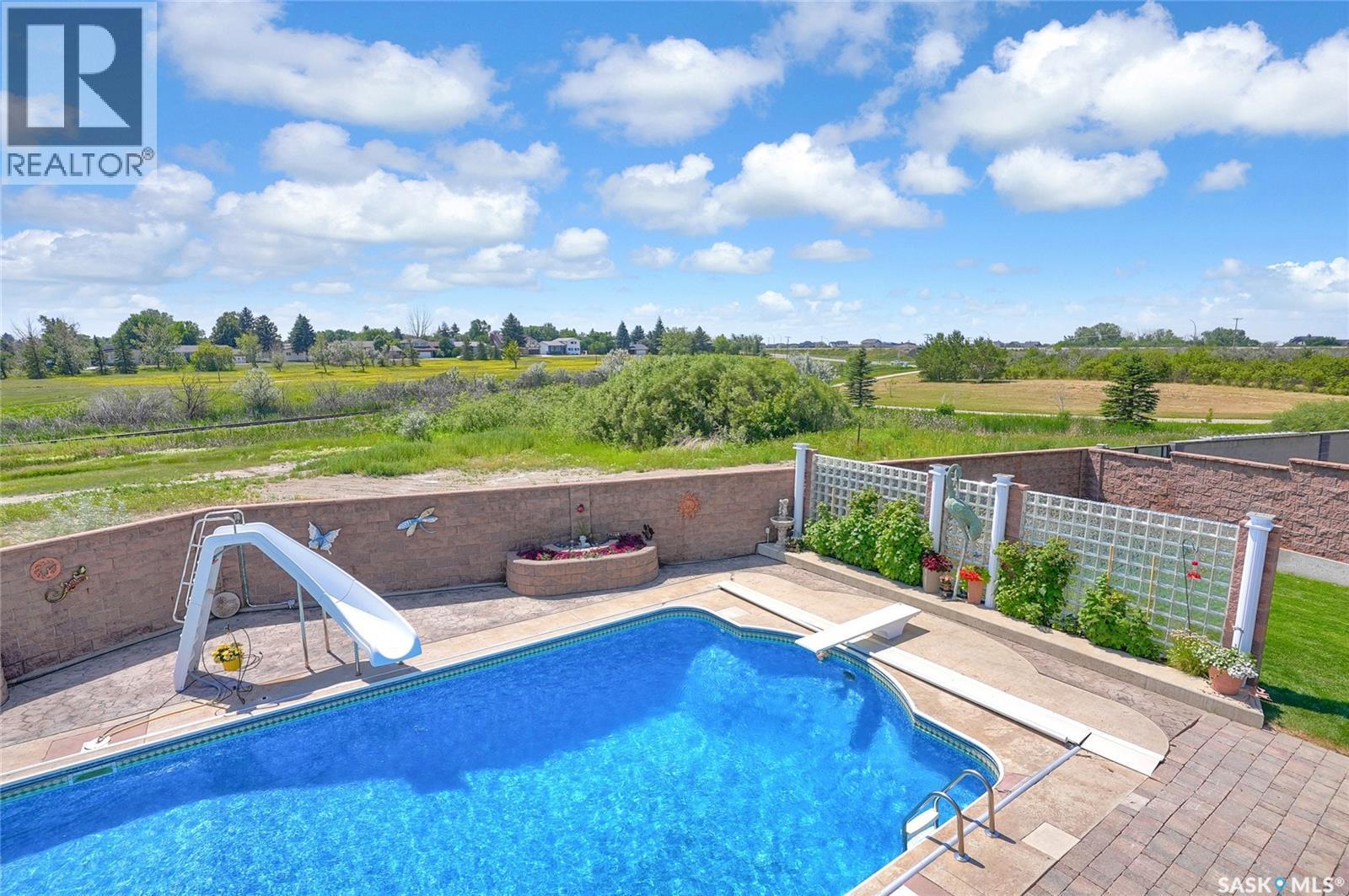 1453 Normandy Drive, Moose Jaw, SK - Outdoor With In Ground Pool With Deck Patio Veranda With View
