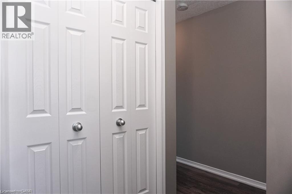 White bi-fold closet doors with panel detailing and brushed nickel hardware - 40 Madeleine Street, Kitchener, ON