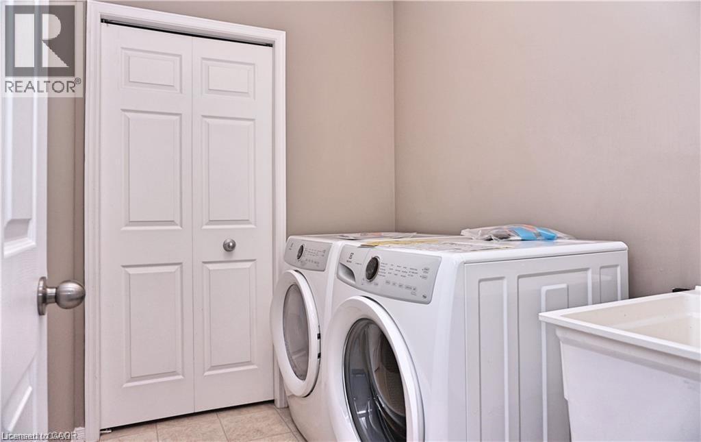 Dedicated laundry area with durable tile flooring - 40 Madeleine Street, Kitchener, ON