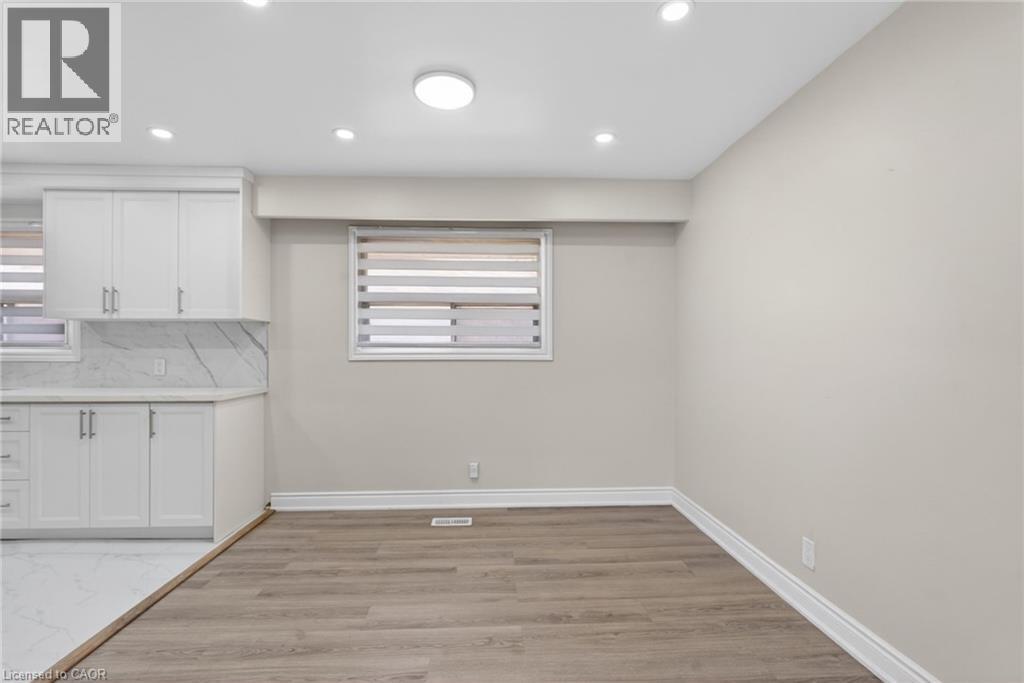 Neutral wall paint and wood-finish flooring provide a versatile foundation - 53 Nicklin Crescent, Guelph, ON - Indoor Photo Showing Other Room