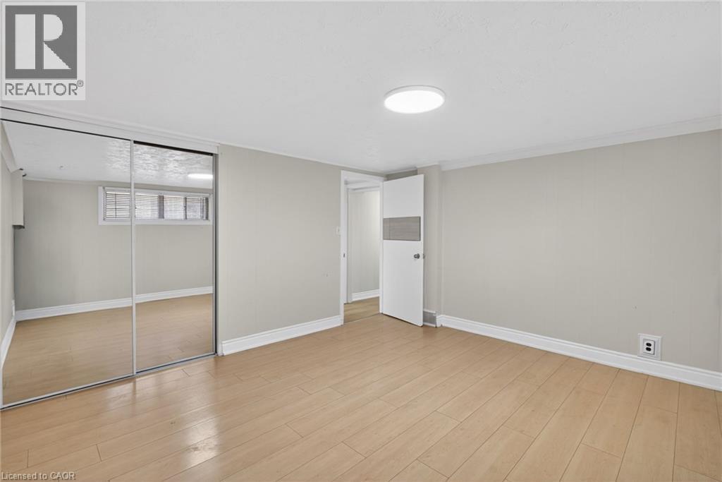 Room featuring wood-finish flooring, light grey walls, and white baseboards - 53 Nicklin Crescent, Guelph, ON - Indoor Photo Showing Other Room