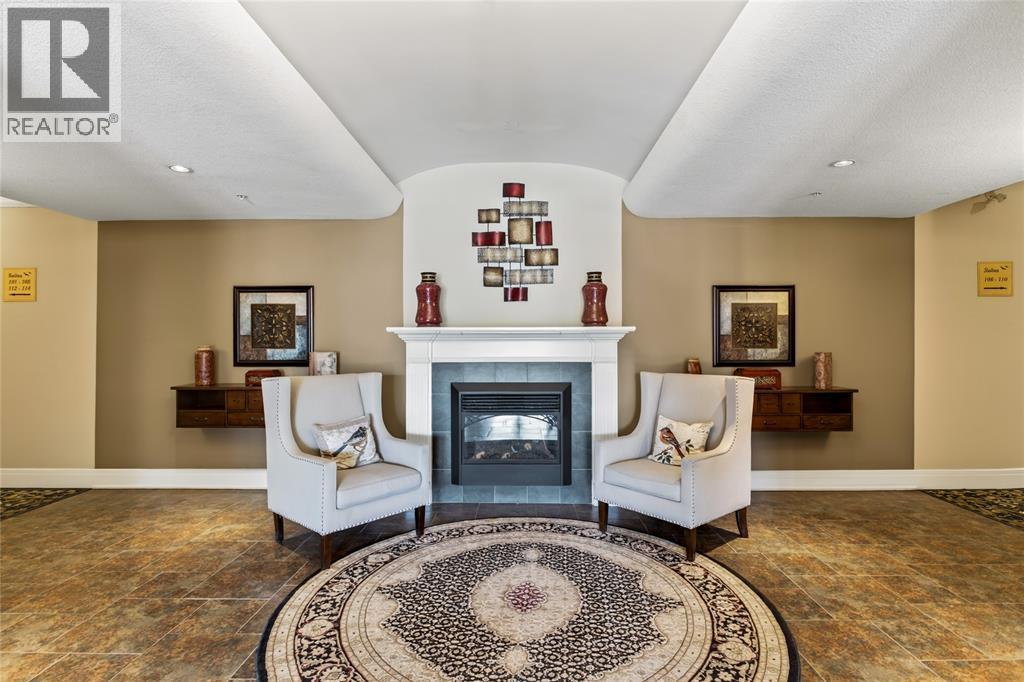 1550 Venetian Boulevard Unit# 310, Point Edward, ON - Indoor Photo Showing Living Room With Fireplace