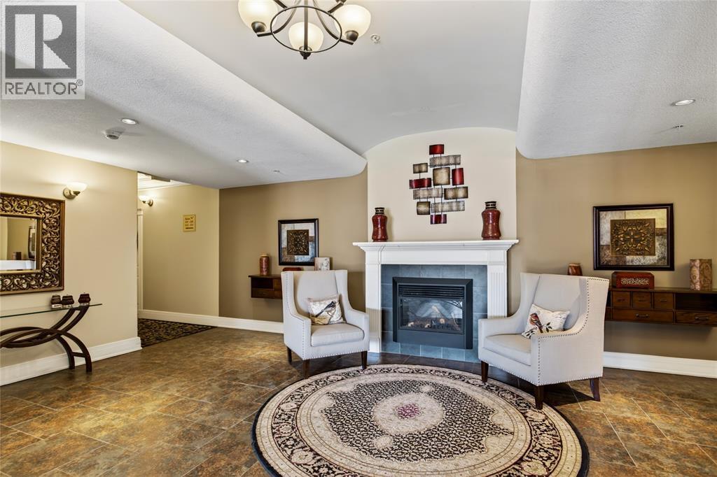 1550 Venetian Boulevard Unit# 310, Point Edward, ON - Indoor Photo Showing Living Room With Fireplace