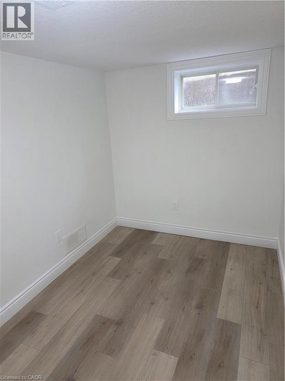 Room featuring wood-finish flooring - 22 Montrose Avenue, Kitchener, ON - Indoor Photo Showing Other Room