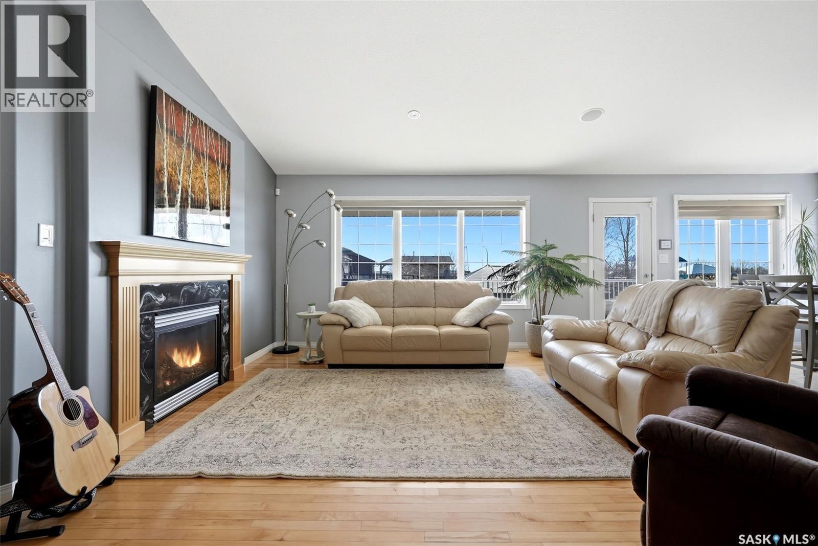 5 Corbin Bay, Grand Coulee, SK - Indoor Photo Showing Living Room With Fireplace