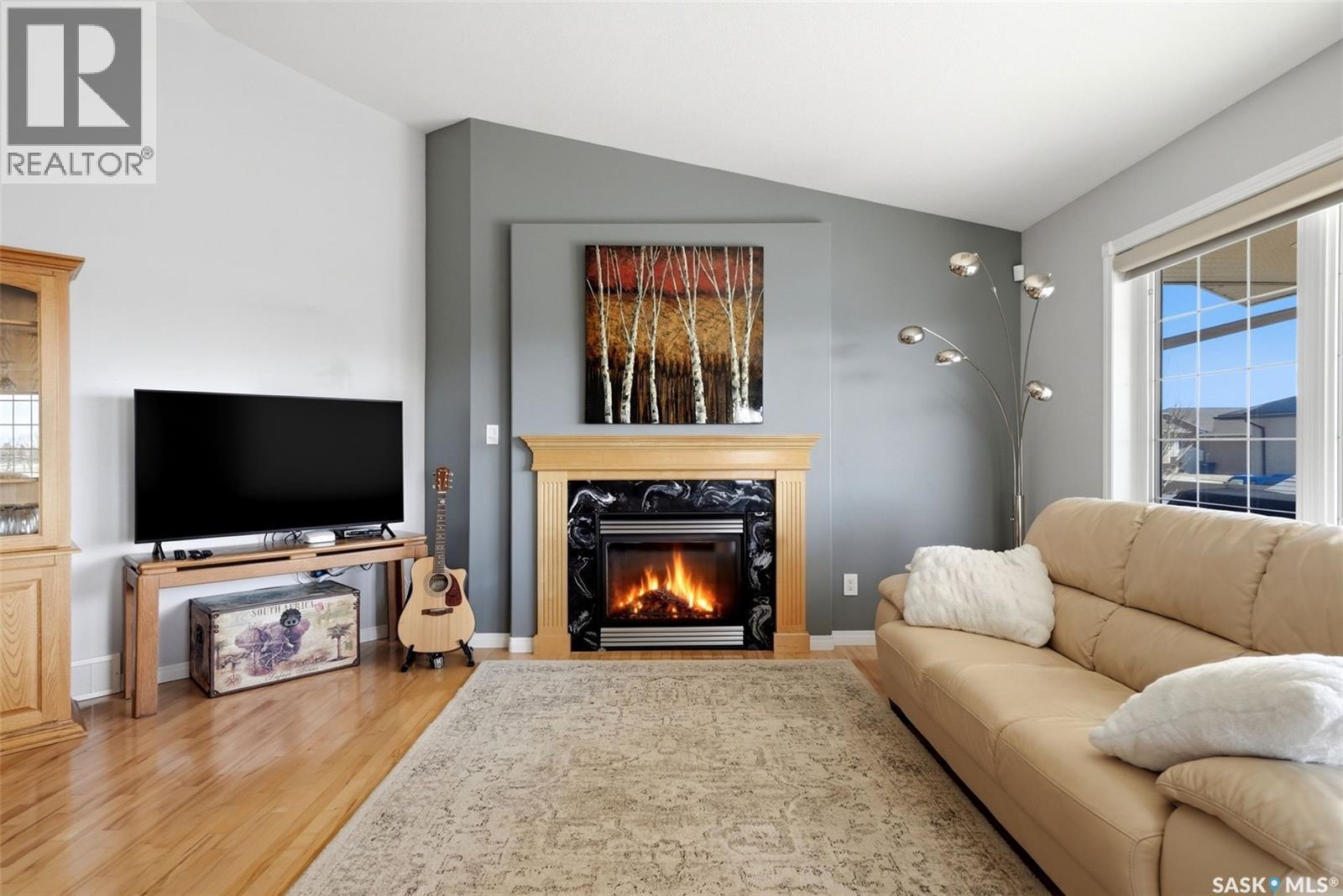 5 Corbin Bay, Grand Coulee, SK - Indoor Photo Showing Living Room With Fireplace