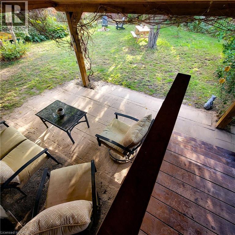 Spacious outdoor deck with wood flooring and a covered patio area - 34 Christopher Drive, Cambridge, ON - Outdoor