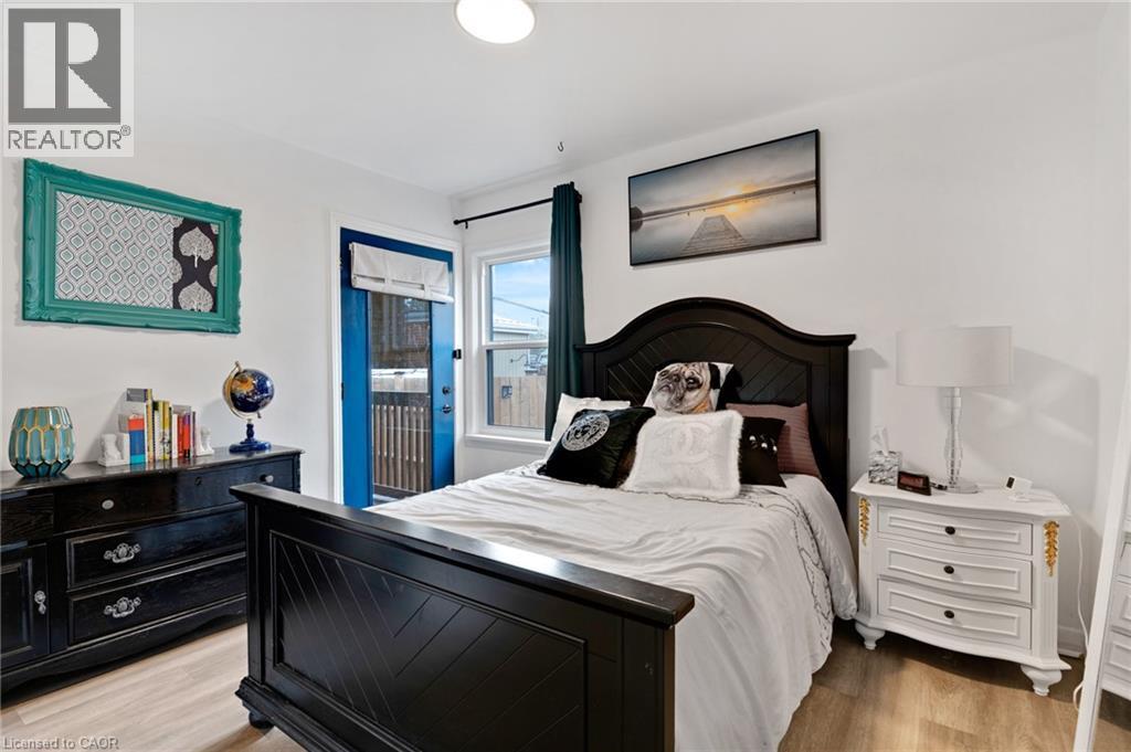 Bright room featuring wood-finish flooring and white walls - 34 Christopher Drive, Cambridge, ON - Indoor Photo Showing Bedroom