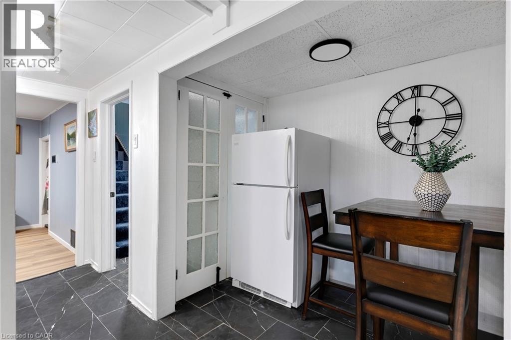Kitchenette area featuring black tile flooring, white walls, and a white paneled ceiling - 34 Christopher Drive, Cambridge, ON - Indoor Photo Showing Other Room