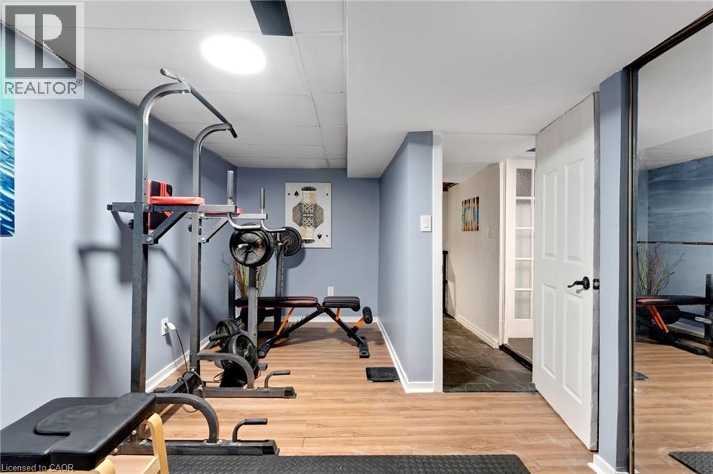Recreation area featuring wood-finish flooring, light blue walls, and a recessed ceiling light - 34 Christopher Drive, Cambridge, ON - Indoor Photo Showing Gym Room