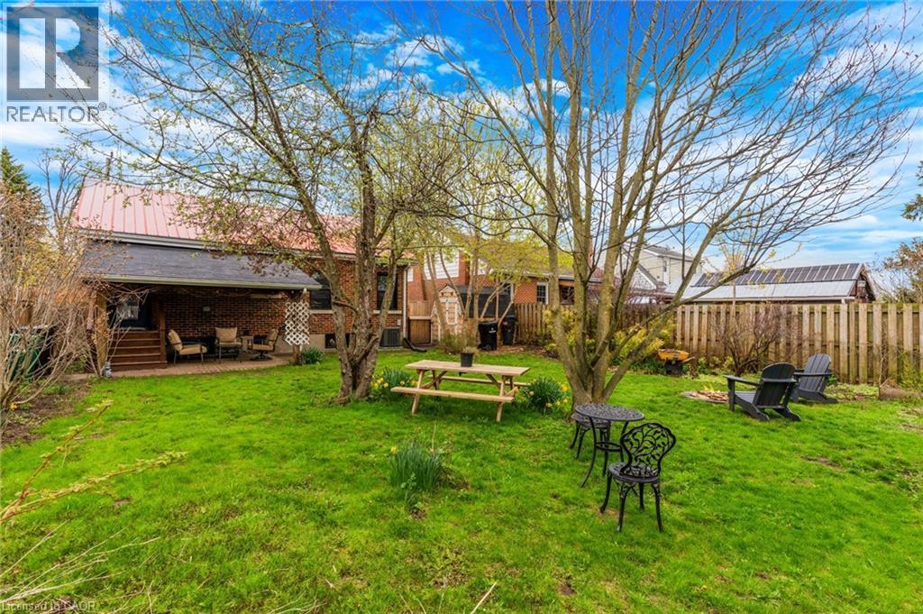 Expansive green lawn with mature trees and a fenced perimeter - 34 Christopher Drive, Cambridge, ON - Outdoor With Deck Patio Veranda