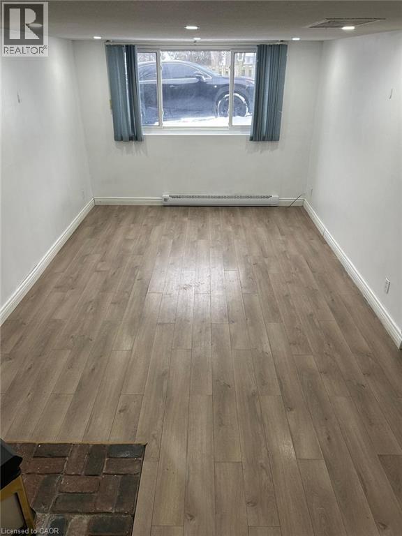 Open room featuring wood-finish flooring, white walls, and recessed lighting - 744 Parkview Crescent, Cambridge, ON - Indoor Photo Showing Other Room