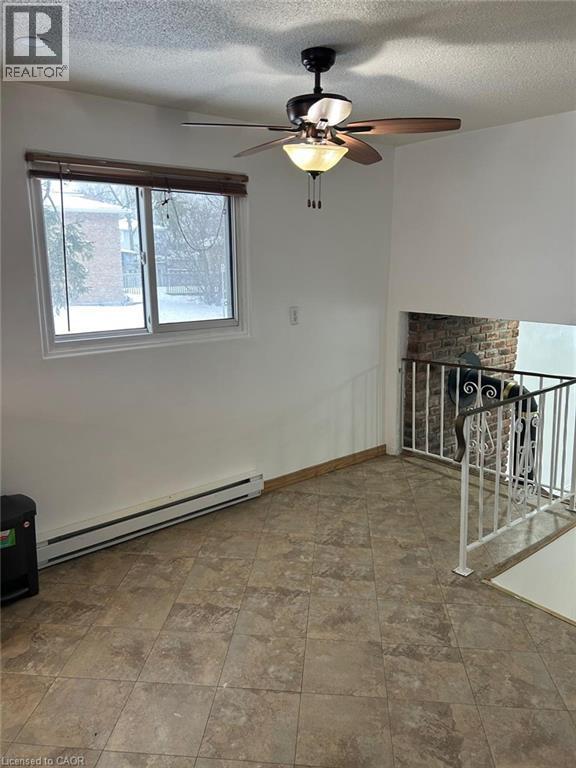 Spacious room featuring neutral-toned tile flooring and white painted walls - 744 Parkview Crescent, Cambridge, ON - Indoor Photo Showing Other Room
