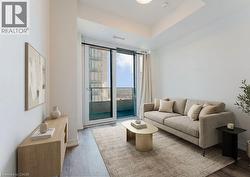 Bright living area featuring a full-height sliding glass door leading to an exterior balcony -