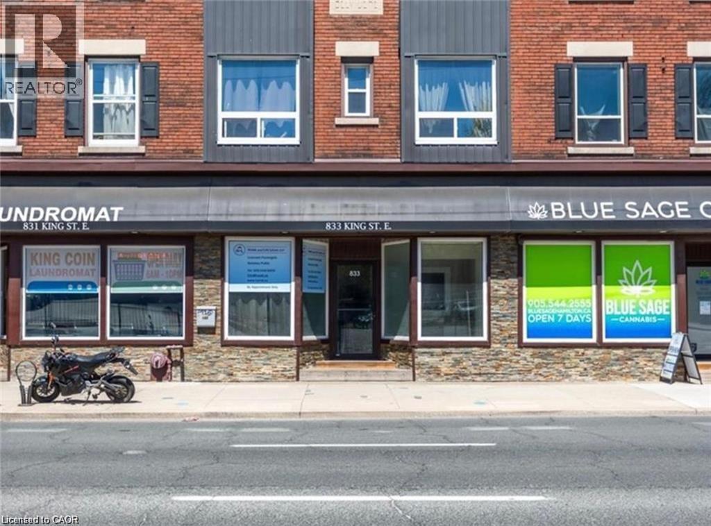 Commercial property featuring a brick facade on the upper level and a stone veneer on the lower level - 833 King Street E, Hamilton, ON