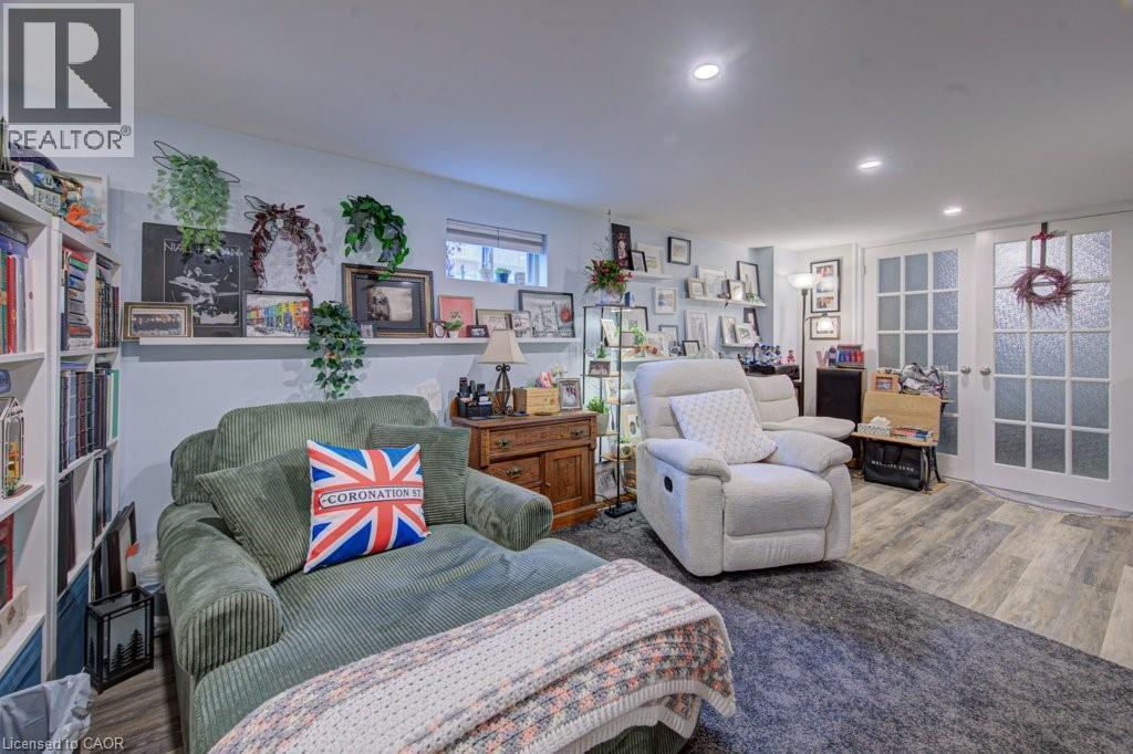 Spacious interior featuring wood-finish flooring, recessed lighting, and a neutral wall color - 1486 Augustine Drive, Burlington, ON - Indoor