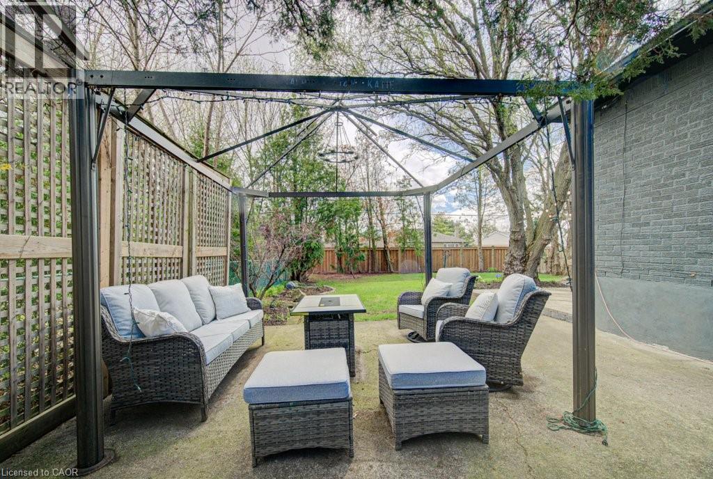 Patio area featuring a dark metal gazebo structure and a concrete surface - 1486 Augustine Drive, Burlington, ON - Outdoor