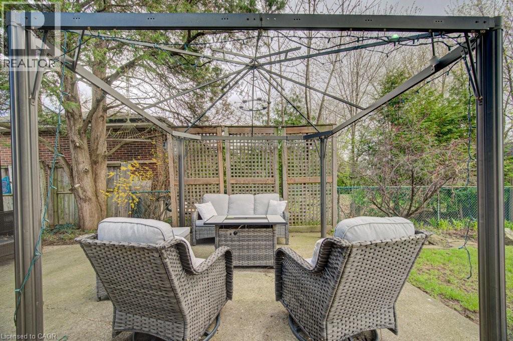 Outdoor patio area featuring a metal gazebo structure and concrete flooring - 1486 Augustine Drive, Burlington, ON - Outdoor