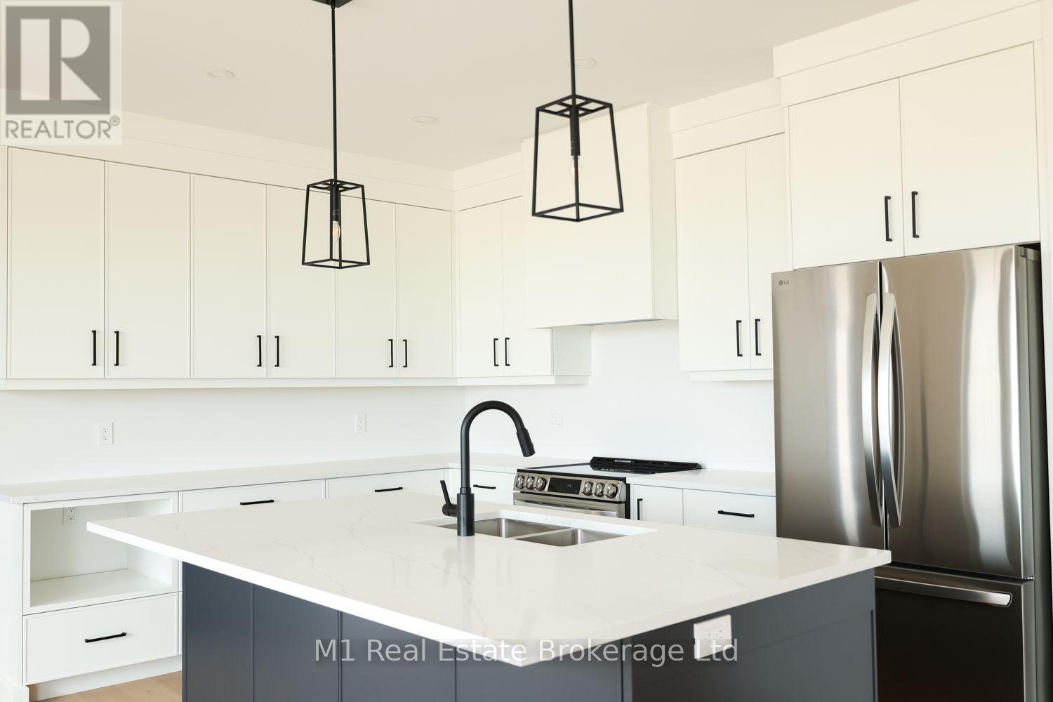 74 Bedell Drive, Mapleton, ON - Indoor Photo Showing Kitchen With Double Sink With Upgraded Kitchen