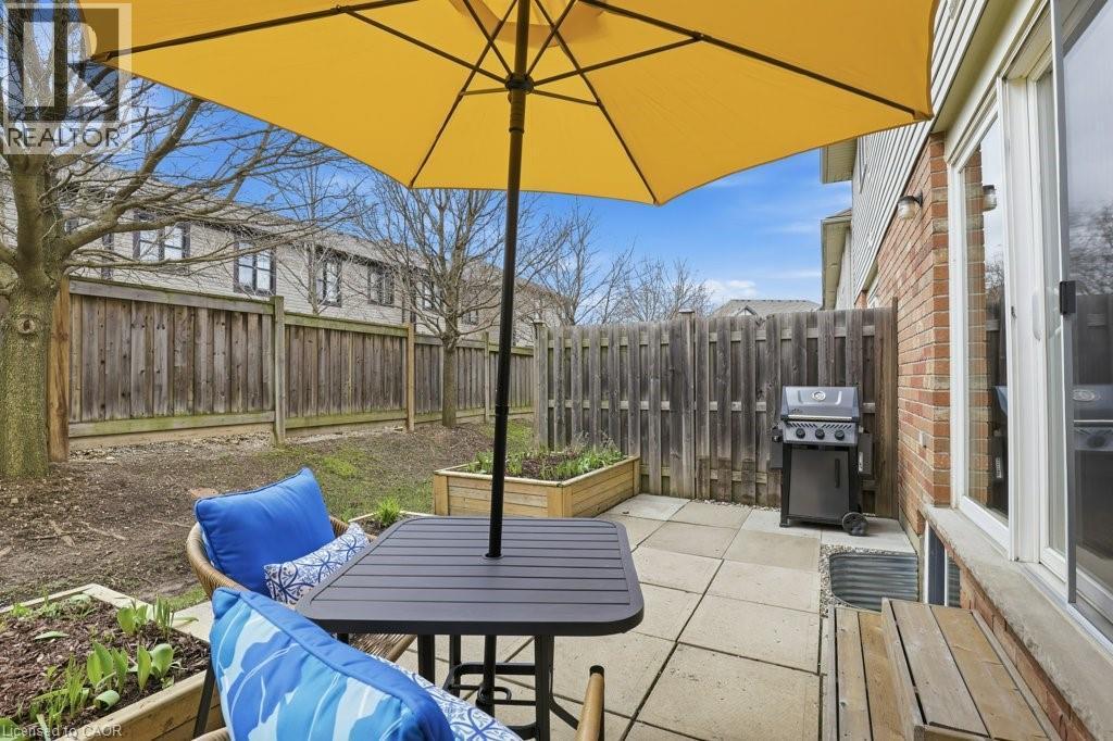 With patio, gardens, and privacy - 42 Fallowfield Drive Unit# 15, Kitchener, ON - Outdoor With Deck Patio Veranda With Exterior