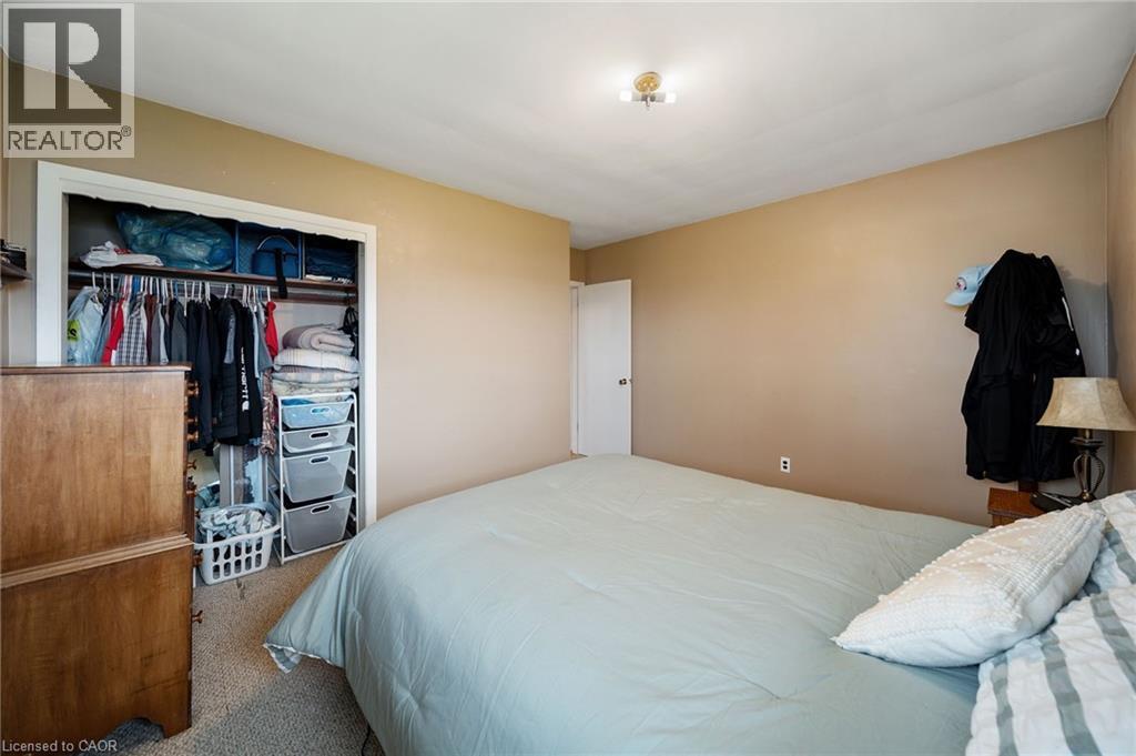 Bedroom featuring neutral wall paint, white trim, and a flush mount ceiling light fixture - 2223 Hall Road, Binbrook, ON - Indoor Photo Showing Bedroom