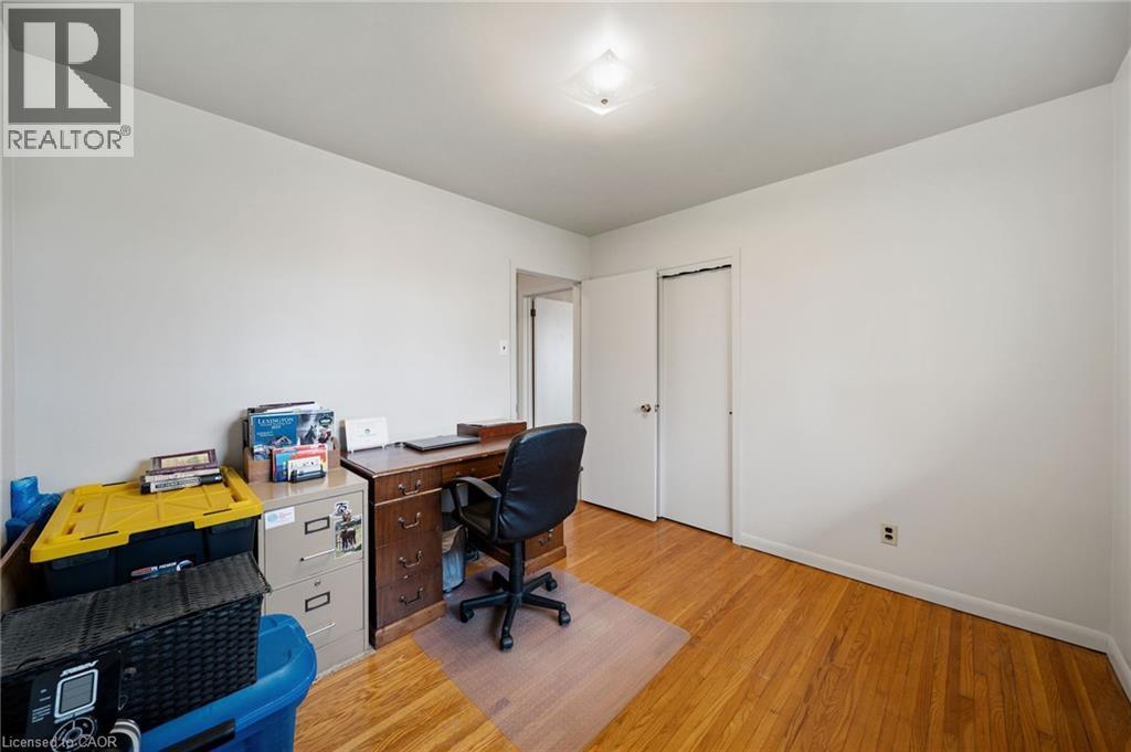 Room with warm wood-finish flooring, white walls, and a flush-mount ceiling light - 2223 Hall Road, Binbrook, ON - Indoor Photo Showing Office